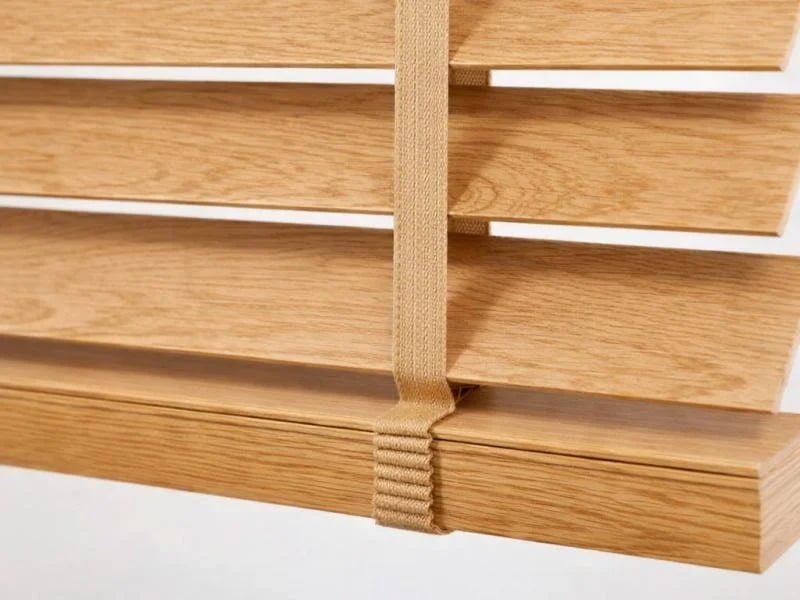 Close-up of wood venetian blind slats showing 50mm width option in stained basswood finish
