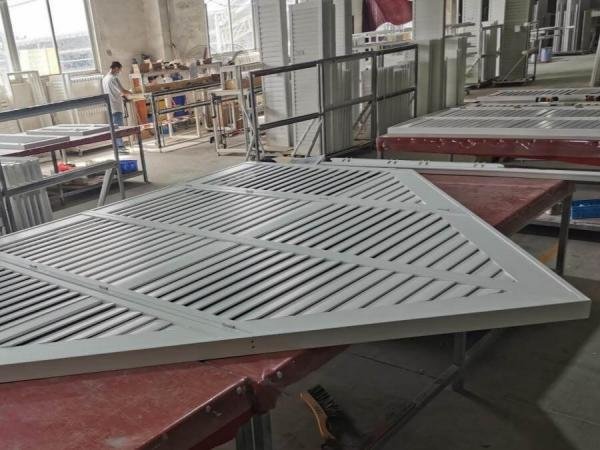 Custom shaped aluminum shutters in an arched window