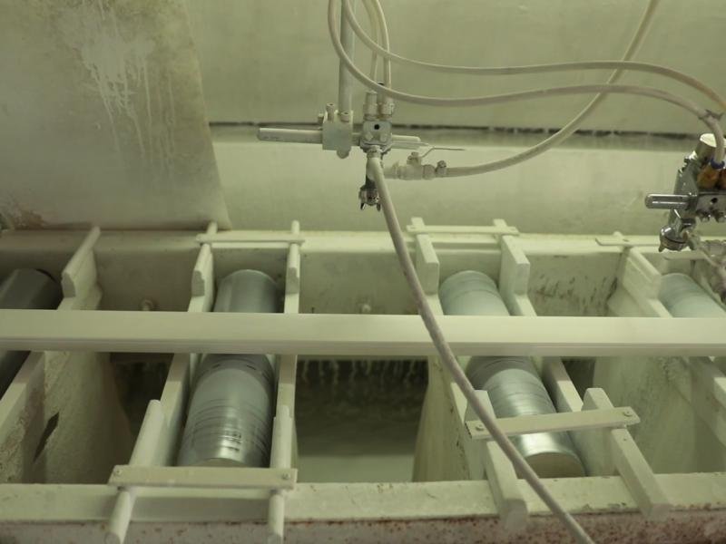 Automated coating line applying water-based primer to plantation shutter components