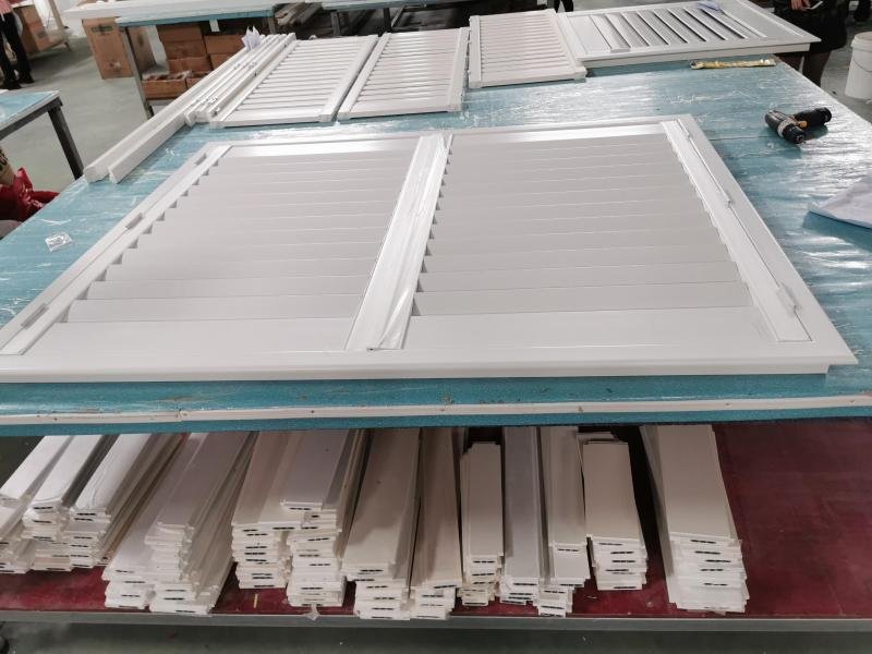 Brand owner reviewing private-label packaging and custom colour collections for window shutters