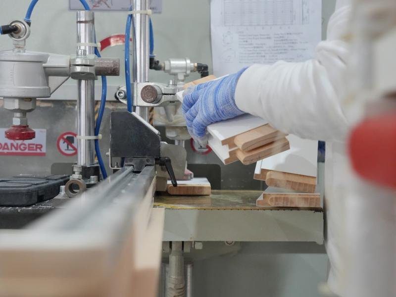 CNC machining centre processing wood components for window shutters
