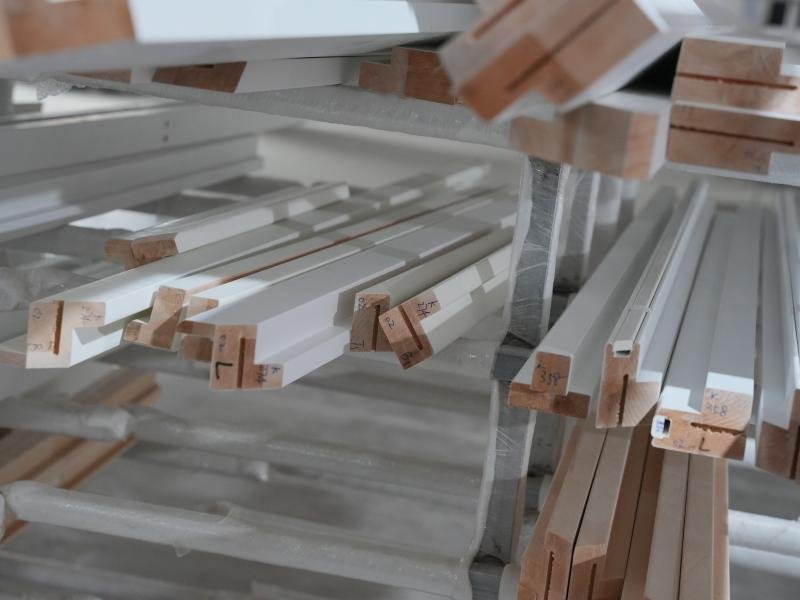 Semi-finished plantation shutter panels stacked and ready for final assembly -- shutter component supplier
