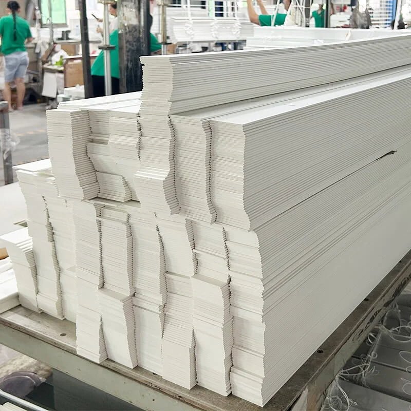 Factory worker operating precision cut-down machinery for venetian blind slats at Goodwood Shutters manufacturing facility