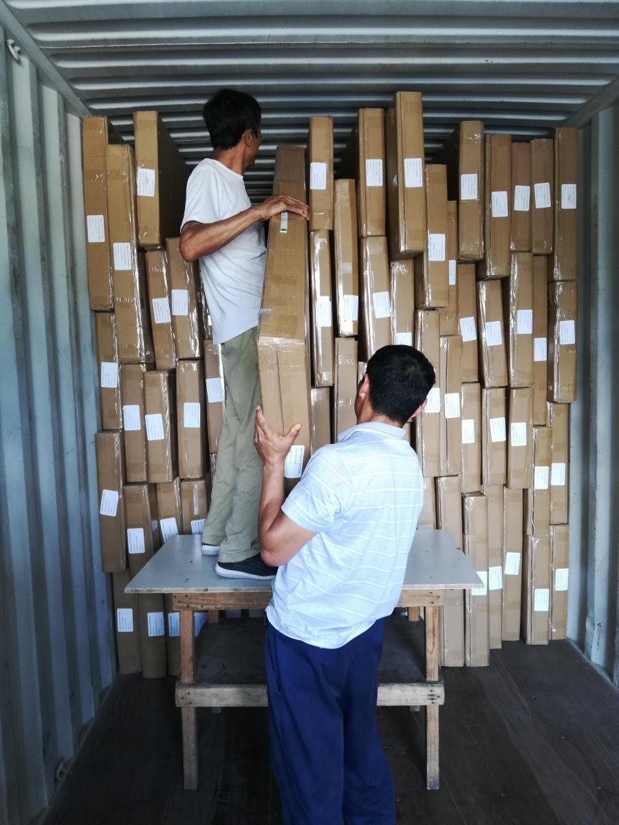 Packed and labelled window covering cartons staged for container loading at factory warehouse